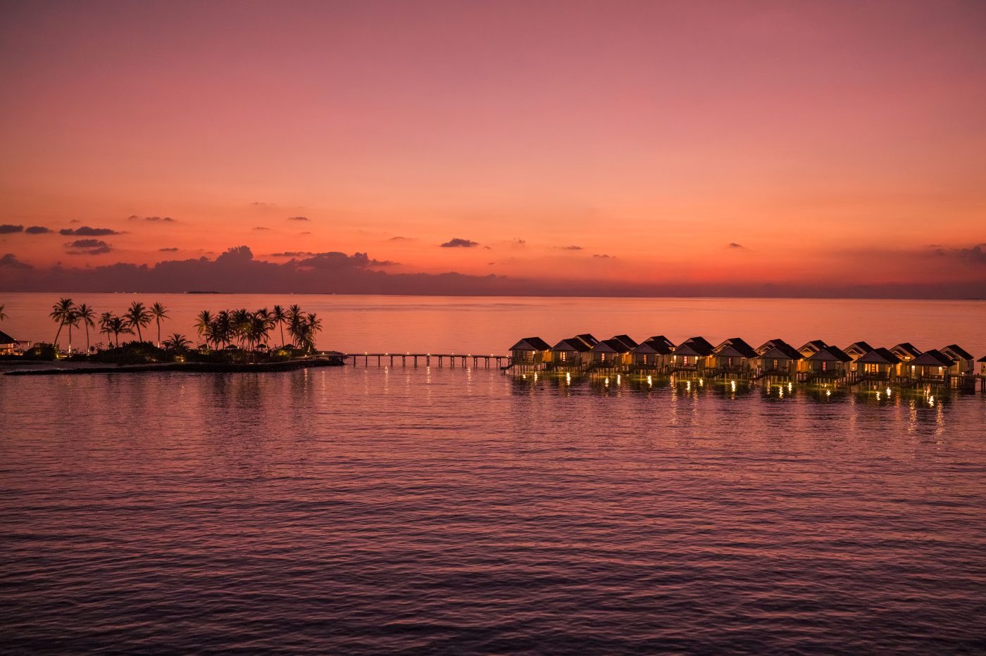 Nest water villas from the air at sunset